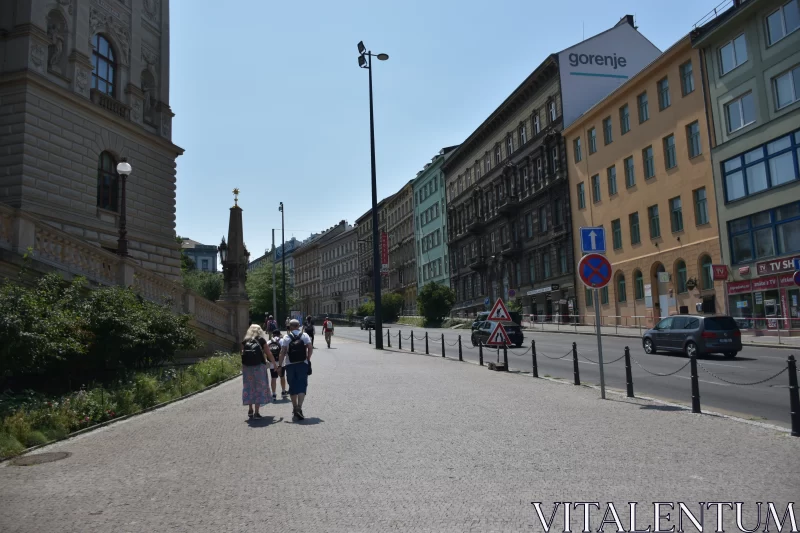 Sunny Strolls: Tourists Exploring Prague's Clean Streets Free Stock Photo