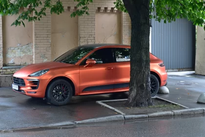 Orange Porsche Macan in Urban Setting - A Subtle Blend of Common Materials and Opaque Resin Free Stock Photo