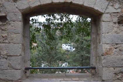 Stone Window Frames Overlooking Mountains - A Cityscape Vista