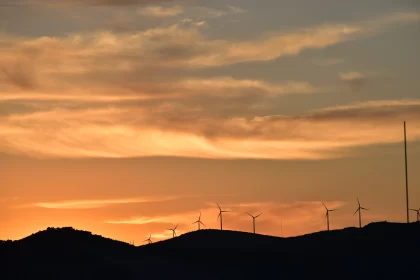 Sunset over Windmill-filled Hills: A Harmony of Nature and Technology
