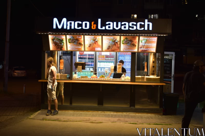 Nightlife in Kiel: Illuminated Fast Food Kiosk Free Stock Photo