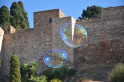 Luminous Soap Bubbles Against Historic Castle