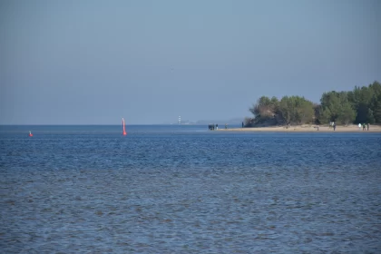 Serene Beach Scene with Sailboat and Kite