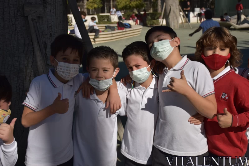 Children Holding Surgical Masks in Urban Environment Free Stock Photo