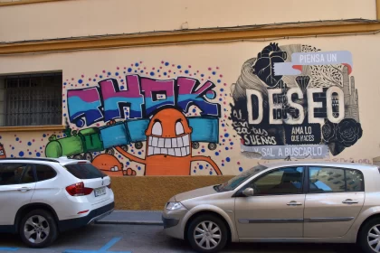Colorful Graffiti Mural and Cars in Urban Landscape