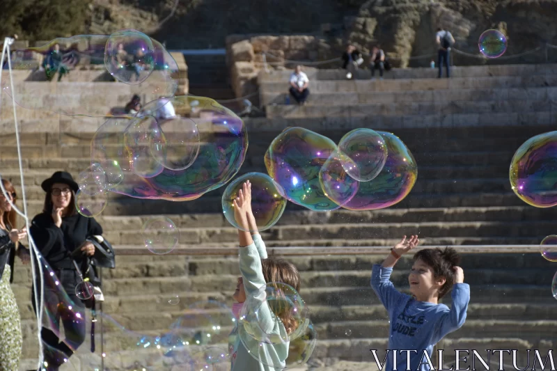 Children's Joyful Play with Soap Bubbles Free Stock Photo