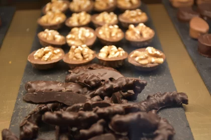 Chocolate Delights: A Raw Display of Nut-Covered Confections in London Free Stock Photo
