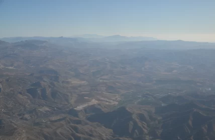 Aerial View of Mountainous Terrain: Light and Shadow Interplay