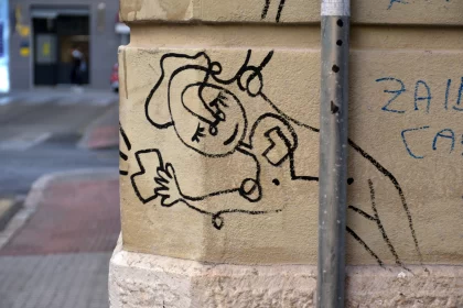 Minimalistic Graffiti Art on City Street Pole Free Stock Photo