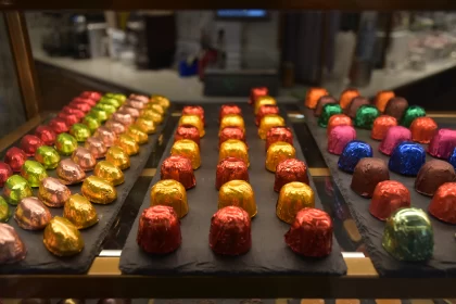 Colorful Chocolates Display - A Luminous Array of Dark Amber and Red Hues