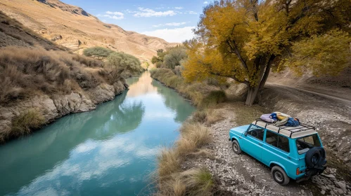 Tranquil Nature Scene with Blue Car on River Bank