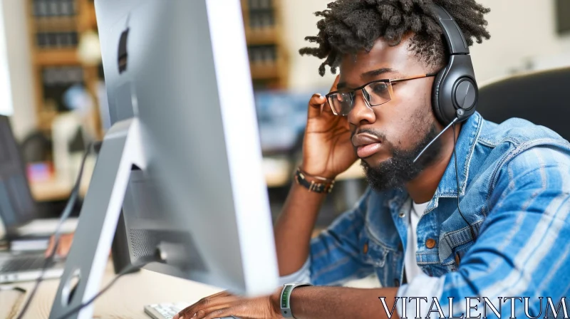 Focused Young Man Working at Computer in Office AI Image