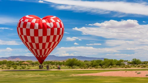 Heart-Shaped Hot Air Balloon Ascending from Grassy Field