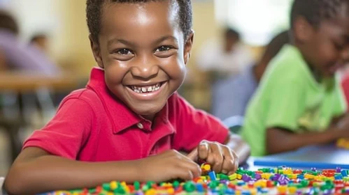 Joyful African-American Boy Playing with Colorful Plastic Blocks