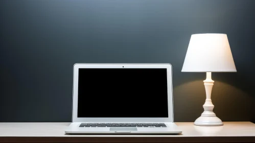 Modern Laptop and White Lamp on Wooden Table