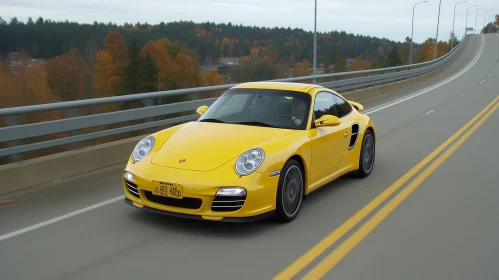 Yellow Porsche 911 Turbo Speeding on Winding Road