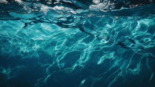 Sunlit Blue Water Surface with Ripples and Bubbles