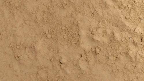 Close-up Sandy Surface with Pebbles and Footprints