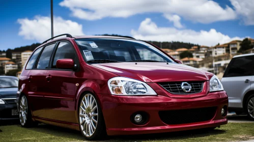 Red Nissan Sensa with Stylish Rims on a Serene Field | Indigenous Culture