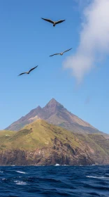 Birds Flying Over a Towering Mountain and Ocean