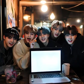 Happy Friends Enjoying Time Together Around a Laptop