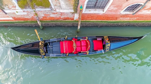 Red Gondola parked on the Gondola Street in Venice, Italy - Aerial Abstractions
