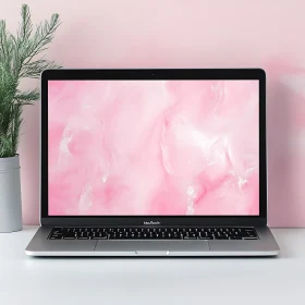 Stylish Workspace with Silver Laptop and Pink Marble Display