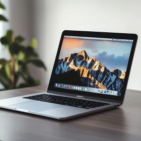 Sleek Laptop Displaying Sunset Mountain Range