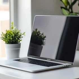 Sleek Workstation with Laptop and Plant