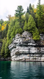 Forest-Crowned Cliff Above Clear Waters