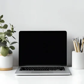 Clean Desk Setup with Laptop and Potted Plant