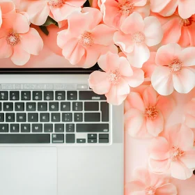 Tech Meets Nature with Pink Blossoming Flowers and Laptop
