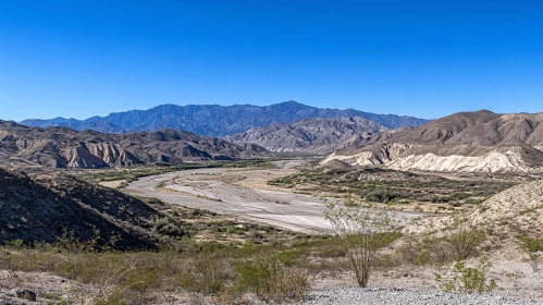 Desert Landscape with a Dry River and Mountains