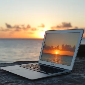 Computer Capturing Sunset by the Sea