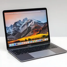 Sleek MacOS Laptop with Mountain Landscape Wallpaper