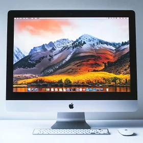 iMac Displaying Mountainous Autumn Scenery