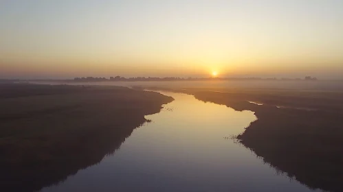 Tranquil Sunrise Reflection on Misty River