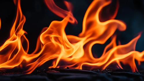 Swirling Orange Flames Above Coals