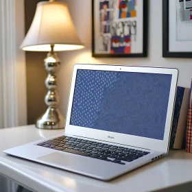 Sleek Laptop on White Desk with Art Decor