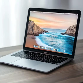 Silver Laptop Displaying Beach Scene on Desk