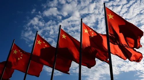 Flags of China Against a Cloudy Sky