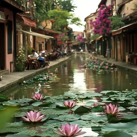 Charming Waterway with Floating Lilies and Bustling Cafes