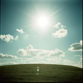 Green Field with Sky and Clouds