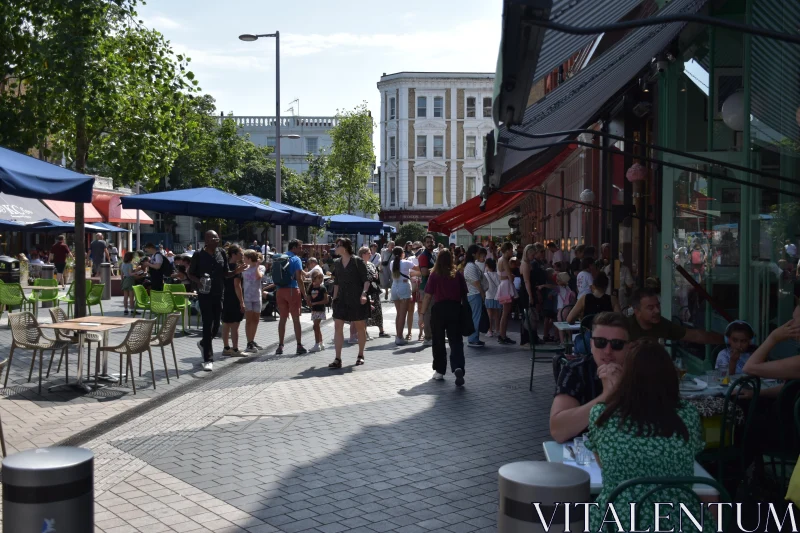 Lively Urban Scene with Outdoor Cafes Free Stock Photo