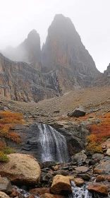 Majestic Mountain Scene with Mist and Waterfall in Autumn