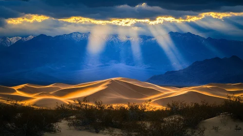 Illuminated Desert Dunes and Cloud-Capped Mountains