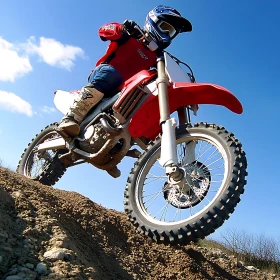 Motocross Rider Leaping Over Hill