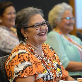 Smiling Woman with Glasses in Orange Attire