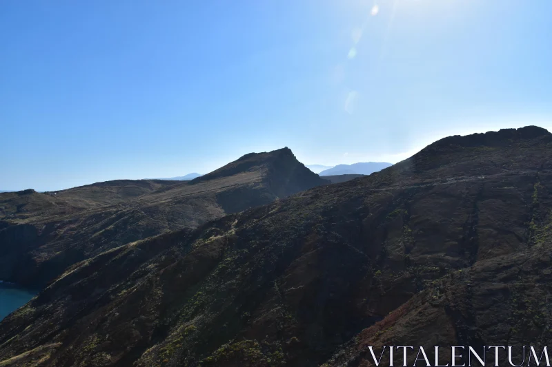 Sunlit Mountain Scene at Dawn Free Stock Photo