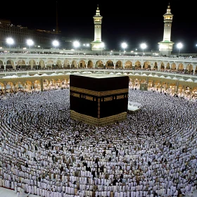 Kaaba at night with pilgrims